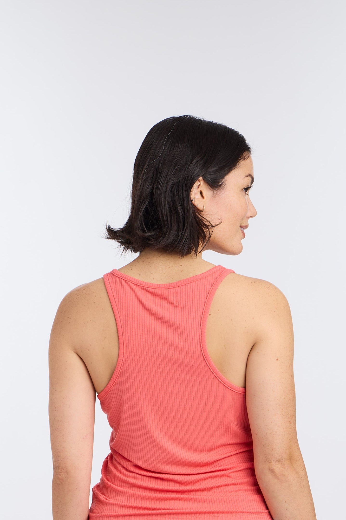 Model in photo of back of Hot Coral Racerback Sleep Tank Top by Nick & Nora