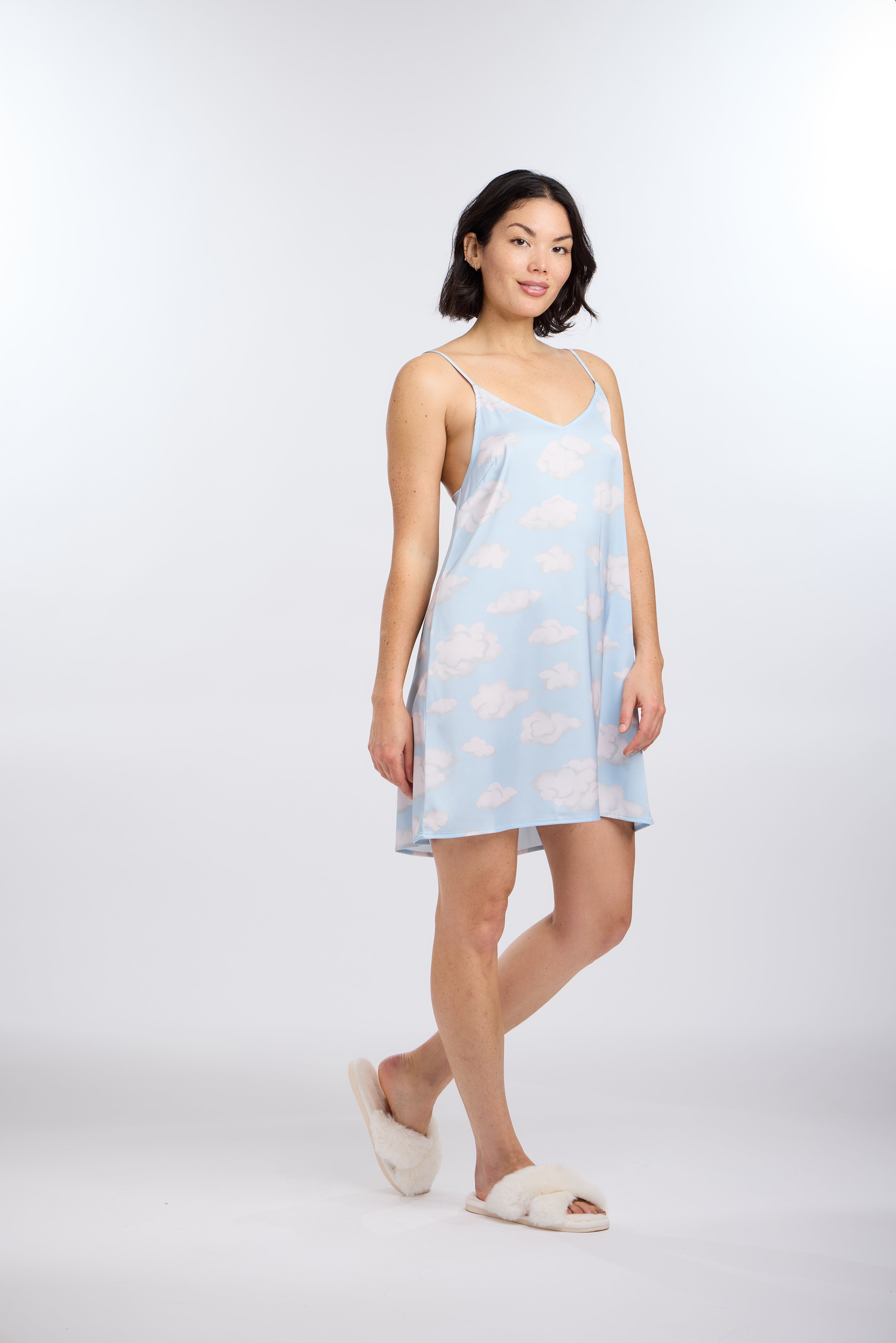 Woman wearing cloud nine chemise with white fluffy clouds against a white background