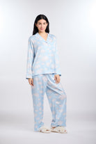 Woman wearing Cloud Nine pajama set with cloud pattern on a white background