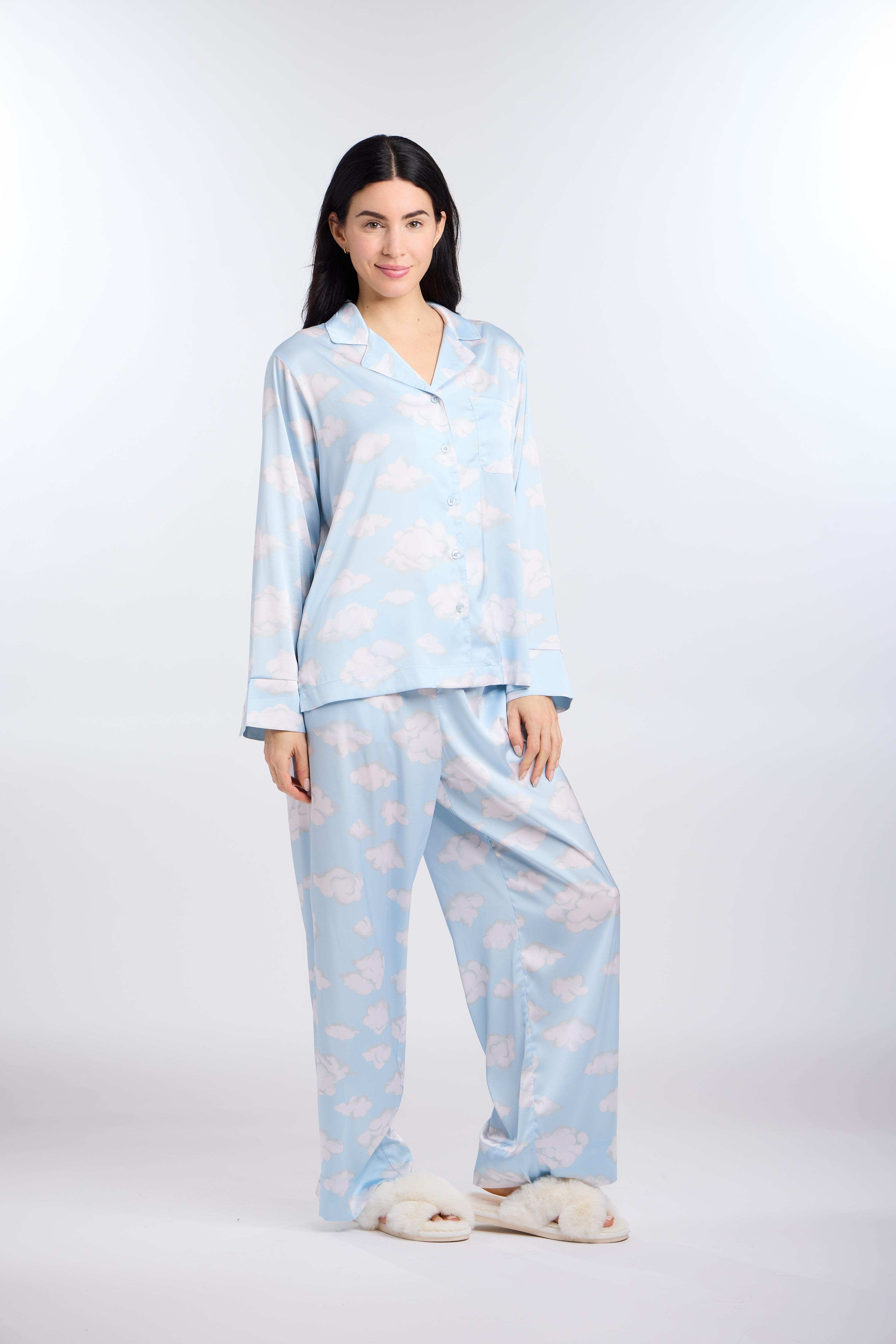 Woman wearing Cloud Nine pajama set with cloud pattern on a white background