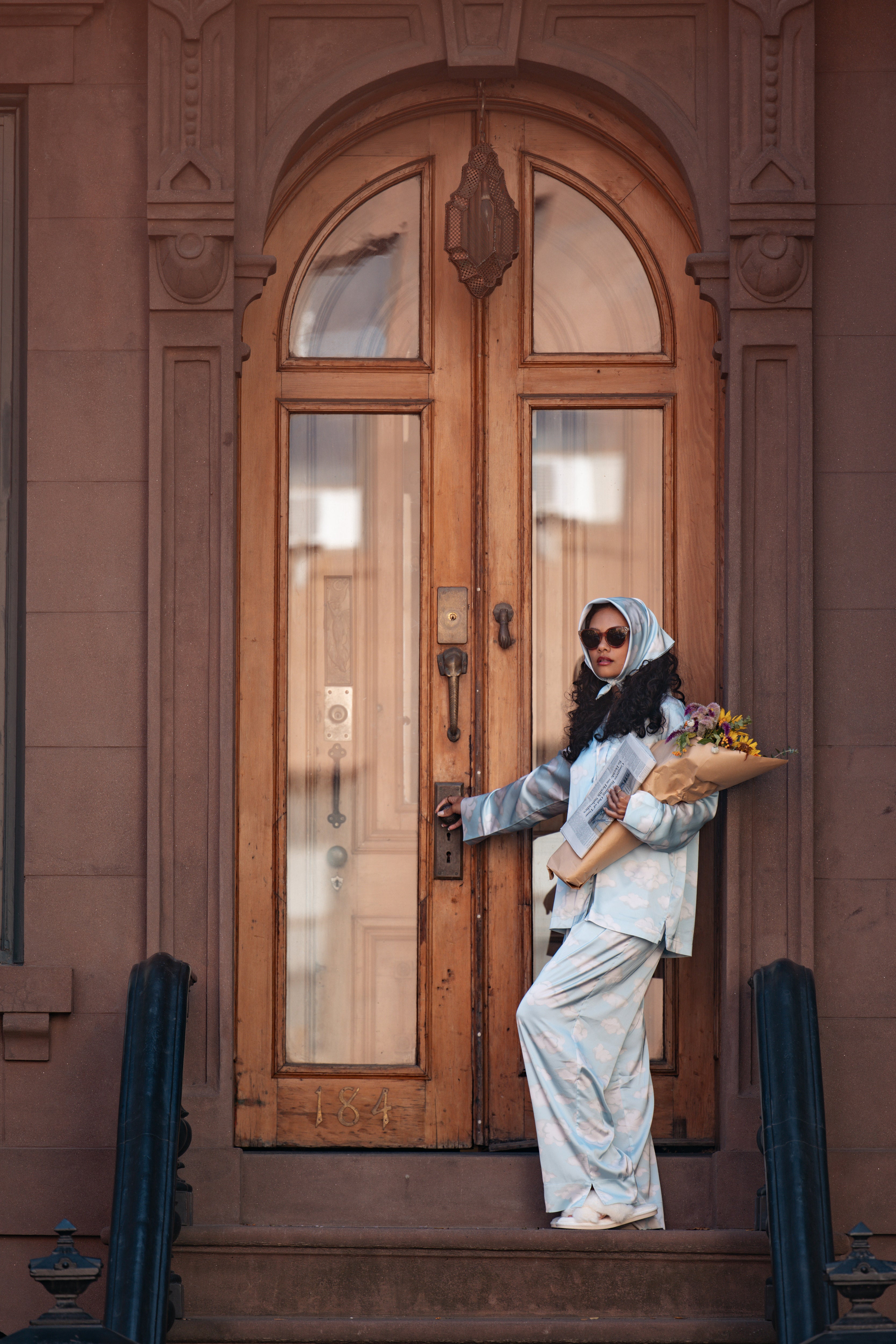 Woman in Cloud Nine PJ Set in front of a NYC Brownstone.
