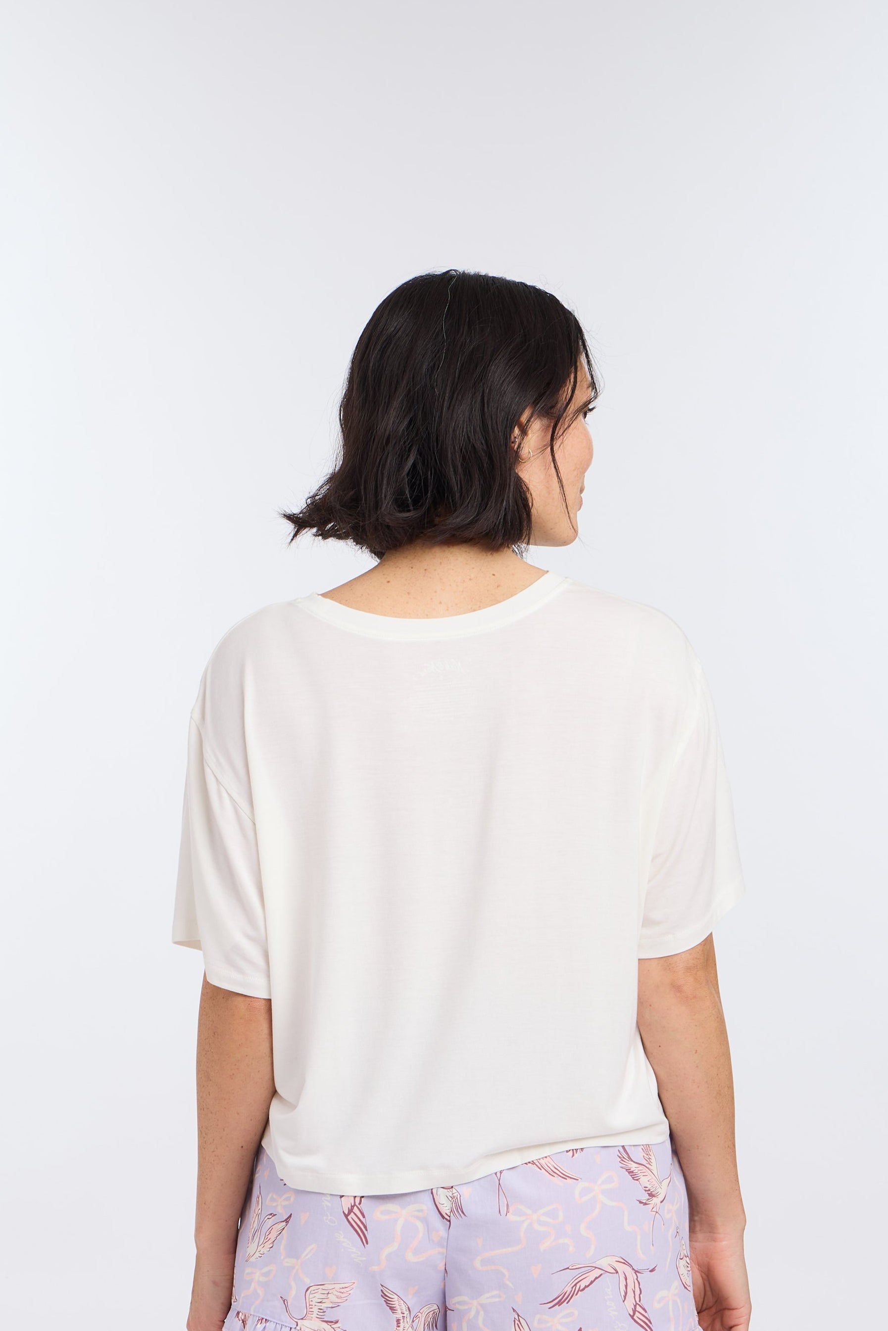 Back view of model wearing Cropped Pajama Sleep Tee with Bird & Bow Design  with Birds of a Feather Sleep Shorts by Nick & Nora