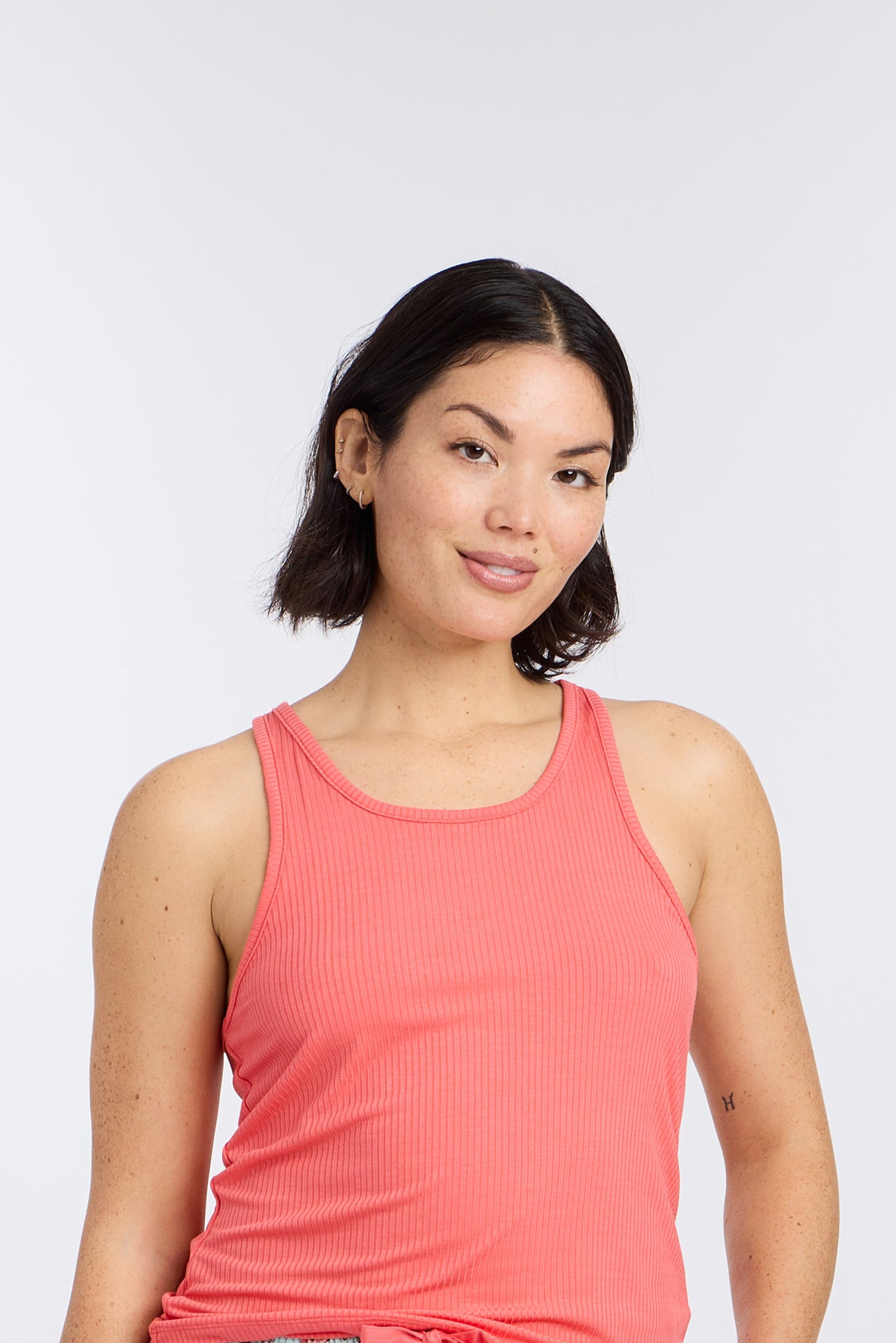 Model wearing Racerback Tank Top in Hot Coral by Nick & Nora