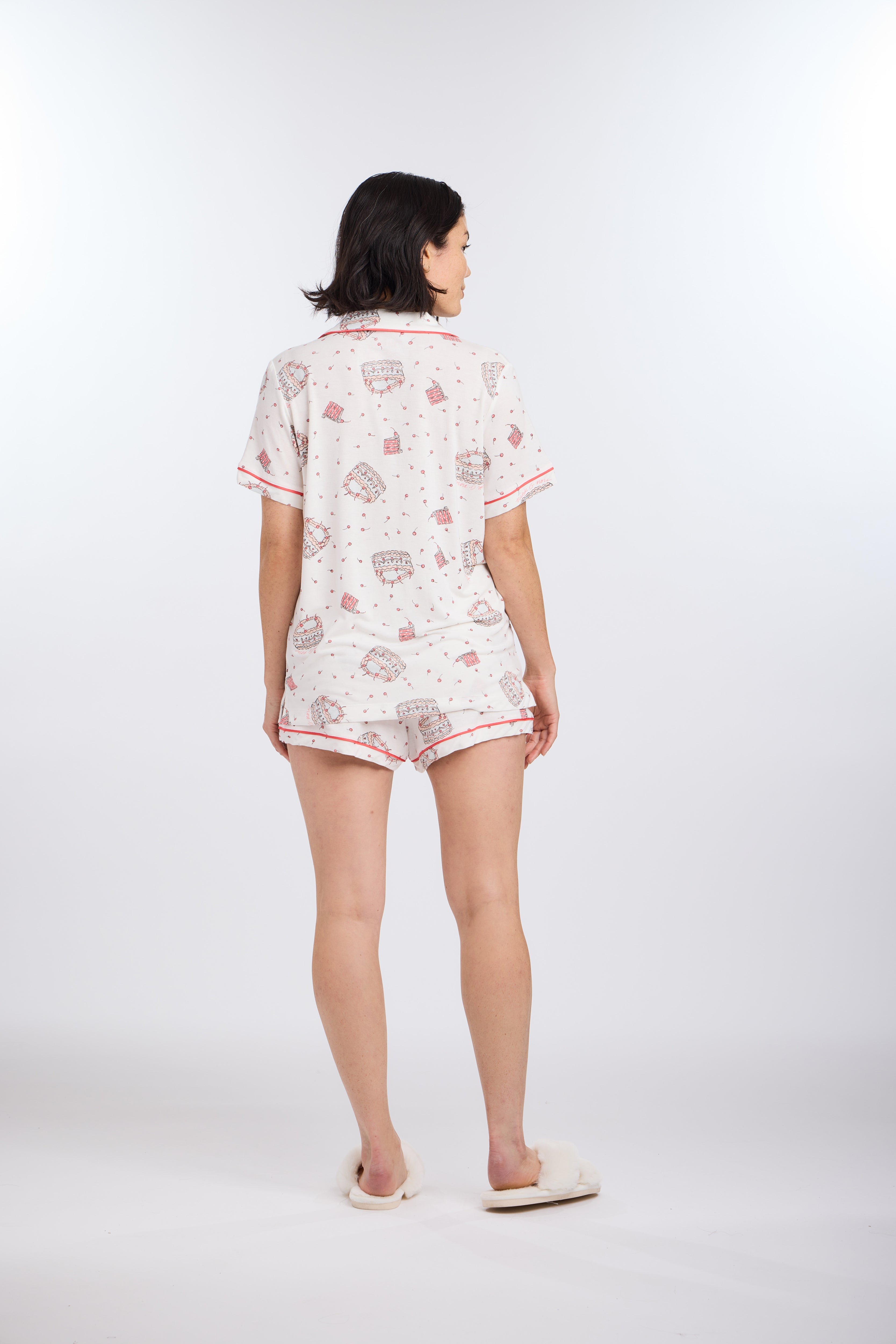 Model facing backwards wearing Let's Eat Cake Short Sleeve Pajama Set by Nick & Nora