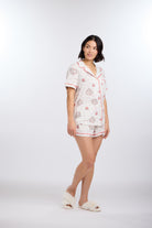 Model turned to side wearing Let's Eat Cake Short Sleeve Pajama Set by Nick & Nora